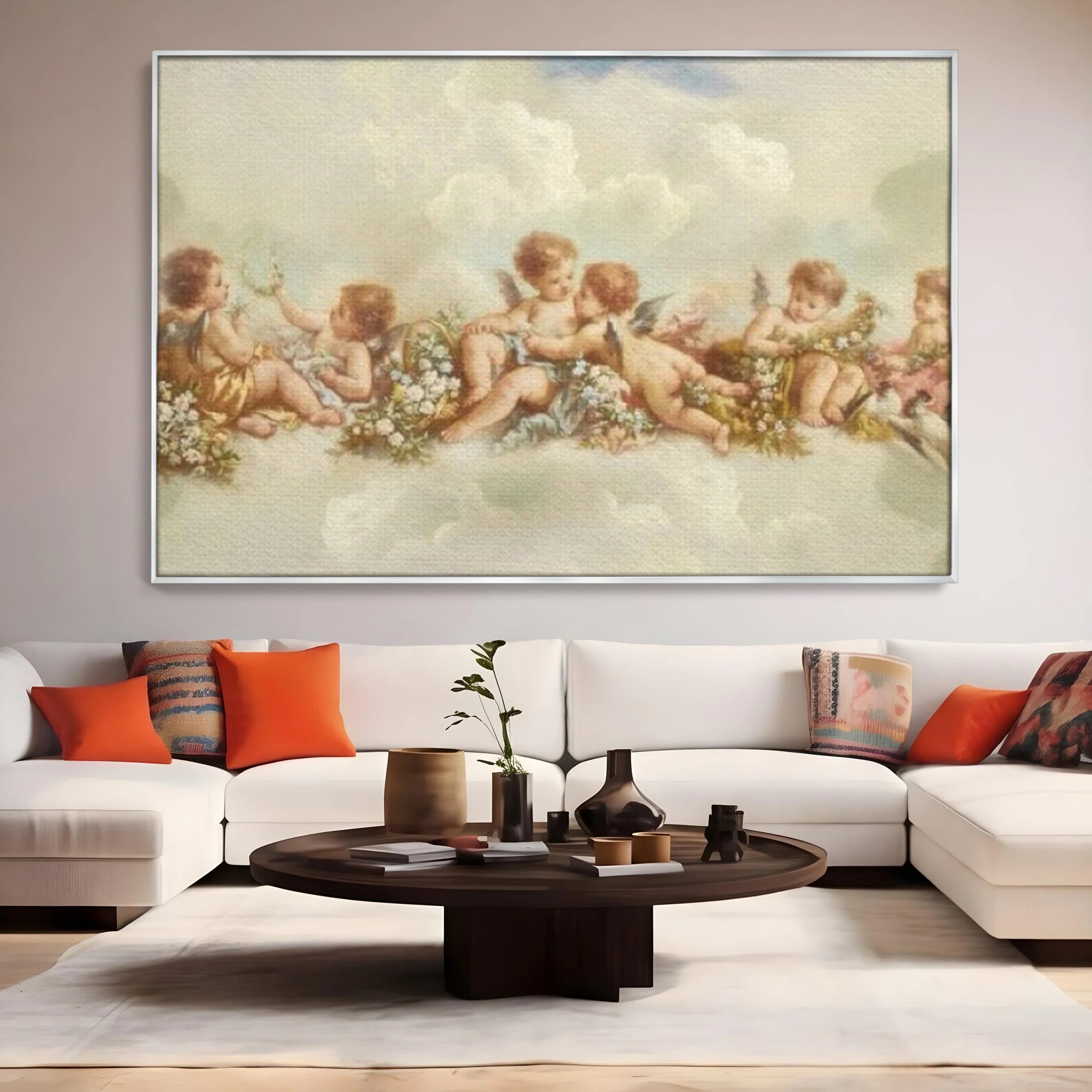 Tablou canvas cu pictura canvas cu ingerase pe nori, in rama de aluminiu argintiu, pe perete intr-un living